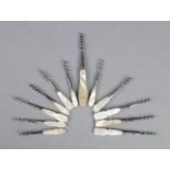 Twelve mother of pearl and white metal perfume corkscrews.