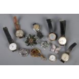 A collection of watches and costume jewellery brooches. Includes manual watches.