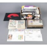 A collection of stamps to include selection of first day covers, album of international examples and