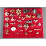 A quantity of costume brooches. Including silver leaf example, coloured paste stone examples, etc.