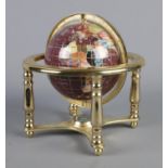 A modern gemstone globe on stand, with compass built into the base. Height: 24cm.