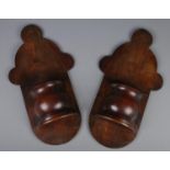 A pair of carved mahogany wall pockets. (51cm x 27cm)