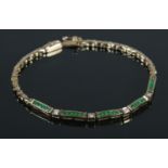 A 9ct Gold, Diamond and Emerald bracelet. Stamped 375 to both ends of clasp. Total weight: 7.72g.