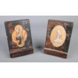 A pair of oriental lacquered bookends. Decorated with figures to one side and landscape scene to the