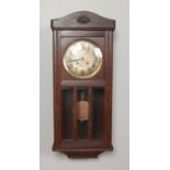 An oak cased wall clock with silvered dial. Chiming on a coiled gong.