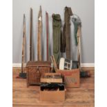 A large collection of vintage fishing equipment. Includes rods, nets, wicker basket, floats and