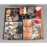 A large tray of assorted costume jewellery. To include loose cameo plaques, bangles, copper