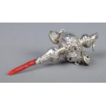 A Victorian rattle and whistle, with repousse decoration and coral handle. Tests as silver.