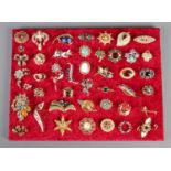 A good assortment of over forty costume jewellery brooches, to include Celtic style, polished