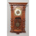 A walnut cased Vienna wall clock.