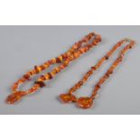 Two amber/copal necklaces, with large pendant pieces. 46.92g.