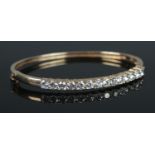 A 9ct Gold and Cubic Zirconia set bangle. Total weight: 12.42g