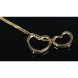 A 9ct Gold twin heart pendant, on 9ct Gold chain. Total weight: 1.96g