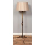 A gilt metal standard lamp, with twisted central column supported by three cabriole feet. Height (