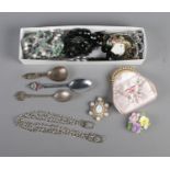 A box of mostly costume jewellery including necklaces and brooches. Also includes three