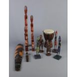 A quantity of carved tribal figures and miniature djembe drum.