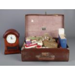 A faux leather suitcase containing an assortment of collectable items. To include a set of six white