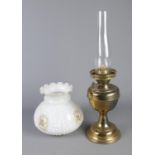 An oil lamp along with floral shade.