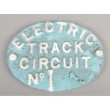An oval cast iron railway sign; Electric Track Circuit No1. Has been repainted.