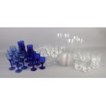 A box of assorted glassware including blue coloured drinking glasses, clear cut glass, etc.