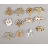 A quantity of military cap badges including The Border Regiment, South Lancashire, The Cheshire