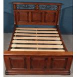 A panelled hardwood & metal double bed. (219cm x 173cm)