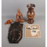 A quantity of carved African items including mask, vase and figure of a seated woman. Also