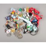 A quantity of lanyards, keyrings and badges to include Disney, The Simpsons, Ford, Star Wars, etc.