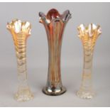 Three ripple carnival glass vases, of varying height. Largest: 30cm high.