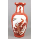 A large Chinese baluster shaped vase, with red ground and panels depicting birds and flowers. 46.