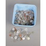 A box of assorted world coins and tokens including Poland, Ecuador, Romania, Italy, etc.