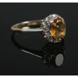 A 9ct Gold and yellow and white paste halo ring. Size O. Total weight: 2.1g