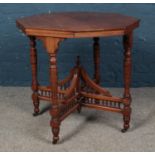 An octagonal window table, on bobbin and galleried stretcher, raised on casters. Height: 74cm,