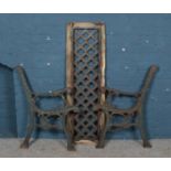 A pair of iron bench ends with back support.