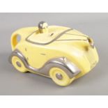 An Art Deco 1930's Sadler novelty racing car teapot in yellow with chrome detailing. Number plate