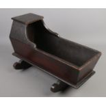 A 19th century mahogany dolls cradle. (42cm x 19cm)