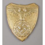 A German Third Reich brass shield crest. 7cm tall.