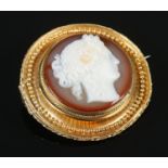 A Nineteenth century hardstone cameo brooch, in a high carat gold mount with rope twist border.