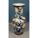 A large floor vase decorated with painted floral decoration. Height 80cm.