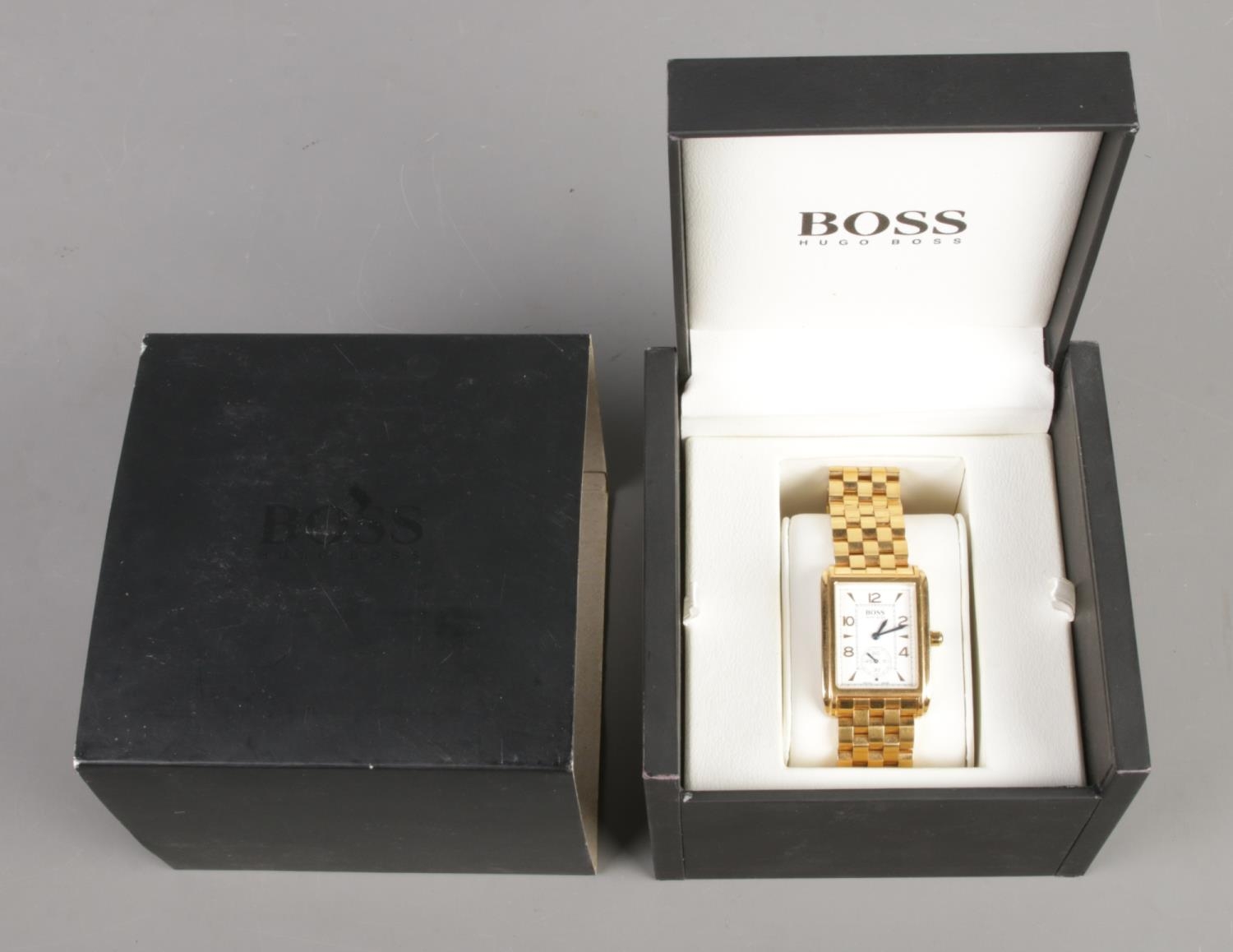 A boxed Gents Hugo Boss quartz wristwatch, on gold coloured strap, with second dial. Back plate