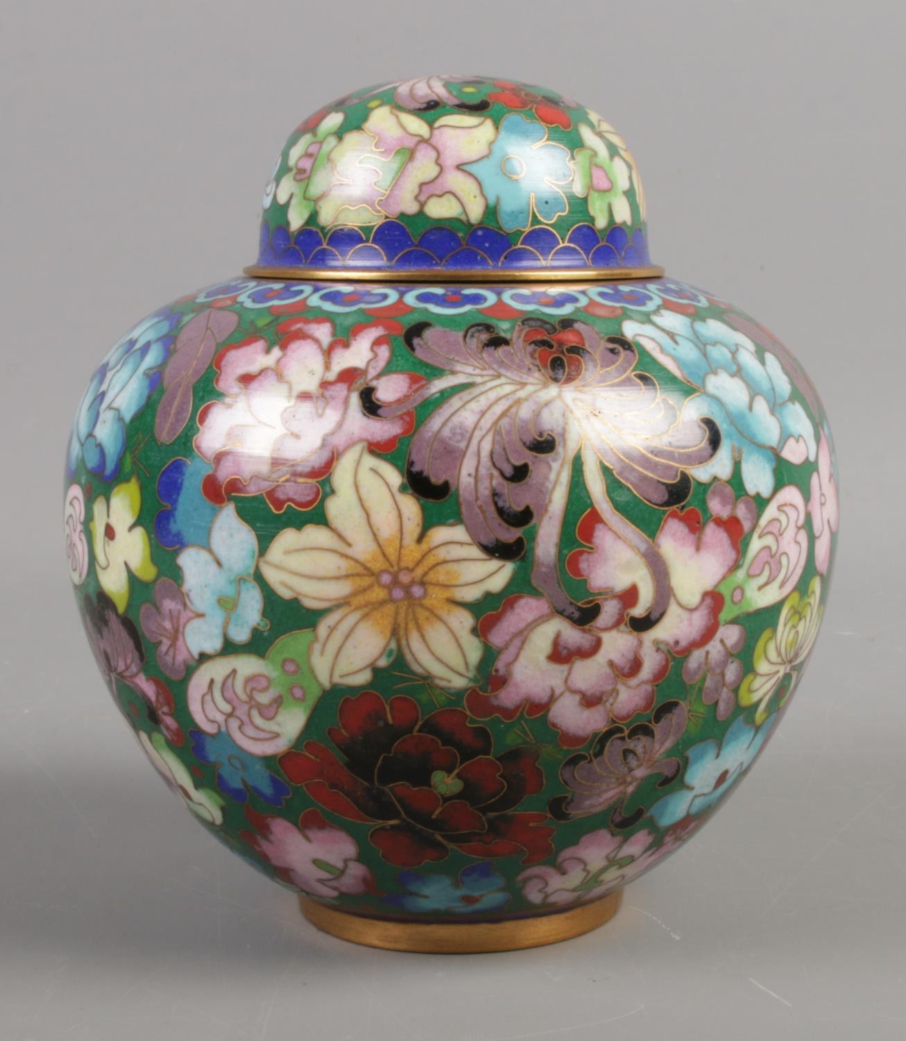 A lidded Chinese cloisonne jar, with floral decoration. 14cm high.