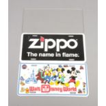 Two US style novelty license plates to include Zippo and Walt Disney World.