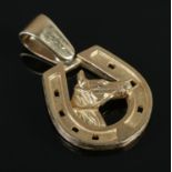 A 9ct Gold horse charm, depicting a horse's head surrounded by horseshoe. 6.1g