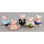 Five ceramic Natwest piggy banks, produced by Wade. Good condition. All plugs present.