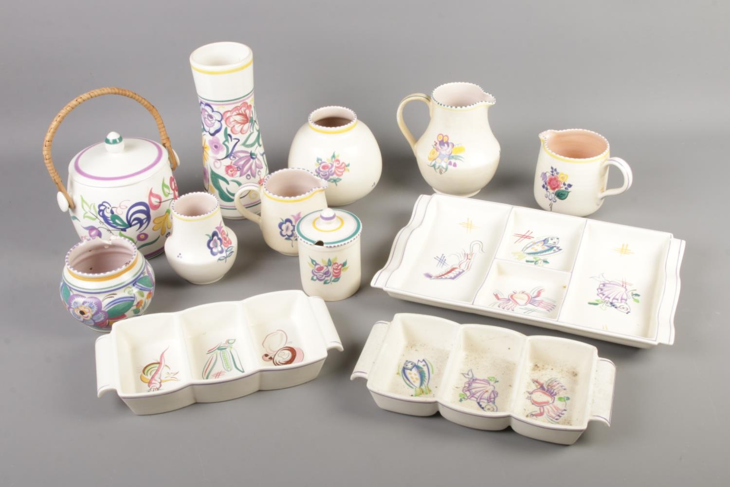 A quantity of Poole pottery including hors d'oeuvres plates, biscuit barrel, jugs etc. Approx. 12