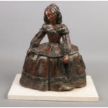A terracotta sculpture modelled as a Georgian lady with crinoline dress on marble base. Signed M