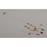 A collection of amber and silver jewellery, including pendant necklace and earrings suite and an