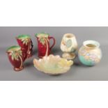Six pieces of Beswick ceramics including three palm tree jugs, two vases and decorative floral