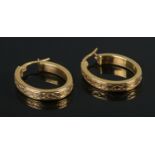 A pair of 9ct Gold hoop earrings, with twisted band decoration. Total weight: 1.95g