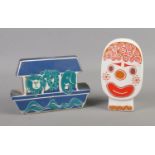 Two Carlton Ware money boxes in the form of a clown and Noah's Ark. Ark cracked and missing stopper.